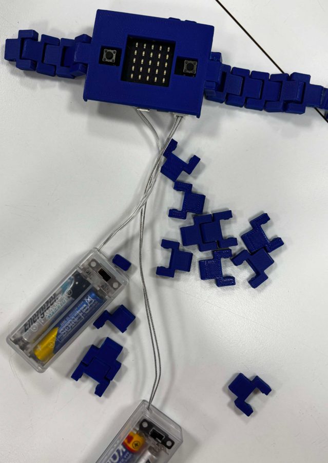 Lumeo prototype: a blue 3D-printed watch with a Micro:bit and wires